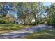 Long driveway leading to a house in a wooded area at 2614 W Ponkan Rd, Apopka, FL 32712