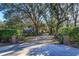 Ornate gate entrance to a private property with mature trees at 2614 W Ponkan Rd, Apopka, FL 32712