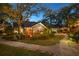 Charming house exterior at dusk with landscape lighting at 2614 W Ponkan Rd, Apopka, FL 32712