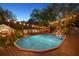 Inviting pool with surrounding deck and string lights at 2614 W Ponkan Rd, Apopka, FL 32712