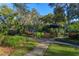 Landscaped pool area with lush greenery and walkway at 2614 W Ponkan Rd, Apopka, FL 32712