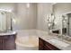 Bathroom boasts a large soaking tub and double vanity at 26148 Avenida Las Colinas # 3B, Howey In The Hills, FL 34737