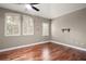 Bright bedroom featuring hardwood floors, plantation shutters, and a ceiling fan at 26148 Avenida Las Colinas # 3B, Howey In The Hills, FL 34737