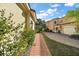 Brick walkway lined with lush landscaping leads to home at 26148 Avenida Las Colinas # 3B, Howey In The Hills, FL 34737