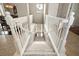 Elegant staircase with white railings and carpeted steps at 26148 Avenida Las Colinas # 3B, Howey In The Hills, FL 34737