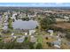 Aerial view of lakefront property in a residential neighborhood at 26409 Evert St, Leesburg, FL 34748