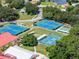 Aerial view of community tennis courts, shuffleboard, and clubhouse at 26409 Evert St, Leesburg, FL 34748