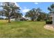 Large backyard showcasing a home with a screened patio at 26409 Evert St, Leesburg, FL 34748