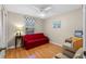 Cozy bedroom with red couch and wood floors at 26409 Evert St, Leesburg, FL 34748