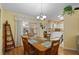 Bright dining area with wood table and chairs, kitchen view at 26409 Evert St, Leesburg, FL 34748