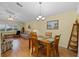 Well-lit dining room with a wooden table and chairs near the living room at 26409 Evert St, Leesburg, FL 34748