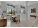 Bright dining room with a wood table, neutral walls, and hardwood floors at 27238 Stoney Brook Dr, Leesburg, FL 34748