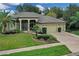 Aerial view showcasing a well-maintained home with a three-car garage and lush landscaping at 27238 Stoney Brook Dr, Leesburg, FL 34748