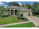 Single-story home with three-car garage, lush landscaping, and a screened porch at 27238 Stoney Brook Dr, Leesburg, FL 34748