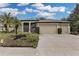 Charming single-story home featuring a spacious three-car garage and lush landscaping at 27238 Stoney Brook Dr, Leesburg, FL 34748