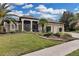Charming single-story home with a well-manicured lawn and beautiful landscaping at 27238 Stoney Brook Dr, Leesburg, FL 34748