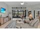 Relaxing living room with sliding doors leading to a screened-in patio at 27238 Stoney Brook Dr, Leesburg, FL 34748