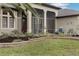 Relaxing screened porch with lounge chair and side table next to the house at 27238 Stoney Brook Dr, Leesburg, FL 34748