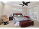 Bedroom with king-size bed, plush seating, and access to balcony at 27527 Briar Patch Pl, Leesburg, FL 34748