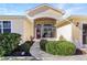 Inviting entryway with red door and nicely landscaped walkway at 27527 Briar Patch Pl, Leesburg, FL 34748