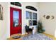 Charming front porch with red door and potted plants at 27527 Briar Patch Pl, Leesburg, FL 34748