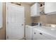 Bright laundry room with washer, dryer, and ample storage at 27527 Briar Patch Pl, Leesburg, FL 34748