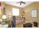 Home office with a comfortable sofa and built-in desk at 27527 Briar Patch Pl, Leesburg, FL 34748