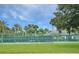 Tennis court with surrounding greenery at 27527 Briar Patch Pl, Leesburg, FL 34748