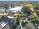 Aerial view of the community, including clubhouse, golf course, and lake at 276 Lawthorn St, The Villages, FL 32162