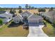 Aerial view of a single-Gathering home with a landscaped yard and driveway at 276 Lawthorn St, The Villages, FL 32162