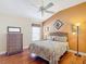 Cozy bedroom with wood floors, ceiling fan, and an accent wall at 276 Lawthorn St, The Villages, FL 32162