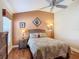 Bright bedroom with wood floors, ceiling fan and wicker furniture at 276 Lawthorn St, The Villages, FL 32162