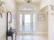 Bright and airy entryway with tile floors and elegant décor at 276 Lawthorn St, The Villages, FL 32162