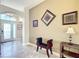 Elegant entryway with decorative wall art and seating at 276 Lawthorn St, The Villages, FL 32162