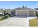 Two-story house with a three-car garage and landscaped yard at 276 Lawthorn St, The Villages, FL 32162