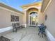 Inviting front porch with ornate seating and decorative wall art at 276 Lawthorn St, The Villages, FL 32162