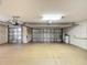 Bright and clean garage with two garage doors and overhead storage at 276 Lawthorn St, The Villages, FL 32162