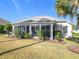 Back exterior of house showcasing a large screened enclosure at 276 Lawthorn St, The Villages, FL 32162