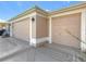 Two-car garage with light beige doors and decorative concrete driveway at 276 Lawthorn St, The Villages, FL 32162