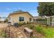 View of the backyard with stone pathway, bench, garden, and home exterior at 2821 Barboza Dr, The Villages, FL 32162