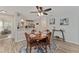 Cozy dining area featuring a round table, stylish chairs, ceiling fan, and a view into the modern kitchen at 2821 Barboza Dr, The Villages, FL 32162