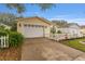 Exterior shot of the home, highlighting the two-car garage and well-maintained driveway at 2821 Barboza Dr, The Villages, FL 32162