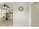 Bright interior featuring wood-look flooring and a clock in the hallway at 2821 Barboza Dr, The Villages, FL 32162