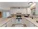 Bright kitchen featuring white cabinets, a stainless steel refrigerator, and modern countertops at 2821 Barboza Dr, The Villages, FL 32162