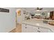 Bright kitchen featuring white cabinets, a stainless steel refrigerator, and modern countertops at 2821 Barboza Dr, The Villages, FL 32162