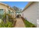 Side patio featuring an outdoor dining set and a view of the surrounding landscape at 2821 Barboza Dr, The Villages, FL 32162