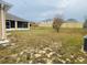 View of backyard, featuring a screened patio and a fence at 3236 White Blossom Ln, Clermont, FL 34711