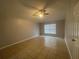 Spacious bedroom with ceiling fan and tile floors at 3236 White Blossom Ln, Clermont, FL 34711