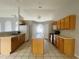 Bright kitchen with light wood cabinets and an island at 3236 White Blossom Ln, Clermont, FL 34711