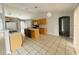 Bright kitchen with light wood cabinets and an island at 3236 White Blossom Ln, Clermont, FL 34711